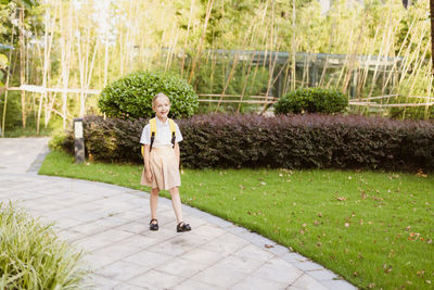 Full length of young woman walking in park