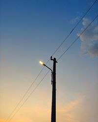 Low angle view of silhouette street light against sky during sunset