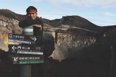 Man standing on rock against sky in mount fujiyama japan