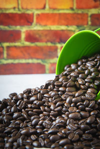 Close-up of roasted coffee beans spilling on table