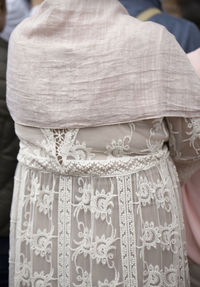 Close-up of woman wearing white dress