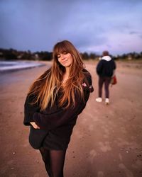 Smiling woman standing at beach