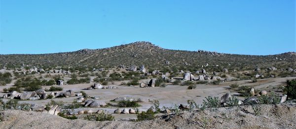 Panoramic view of landscape and mountains against clear blue sky