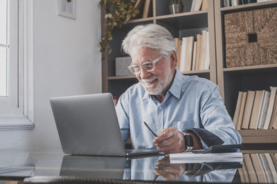 Young man using laptop at home
