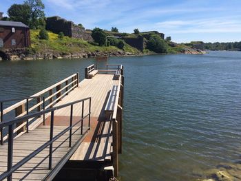 Pier over lake against sky