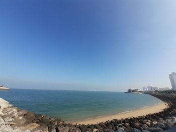 Scenic view of sea against clear blue sky
