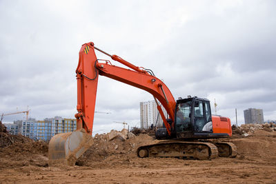 Red excavator during earthmoving at construction site. backhoe dig ground for the construction 