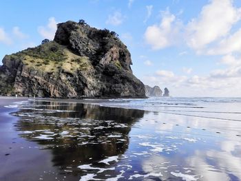 Rocks in sea against sky