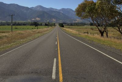 Road by mountain against sky