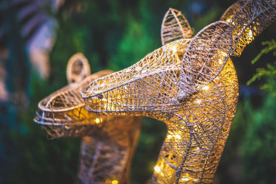 Close-up shot of a deer-shaped coil metal design with twinkling lights. christmas lights decoration.