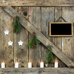 Close-up of christmas decorations hanging on wood