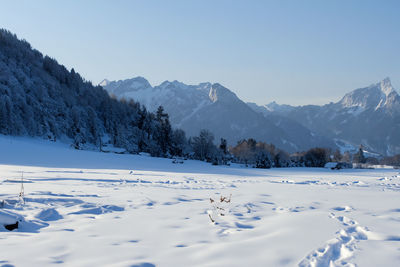 Scenic view of snowcapped mountains against clear sky