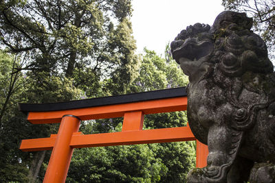 Low angle view of statue against trees