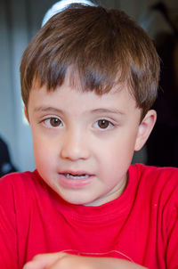 Close-up portrait of boy wearing red t-shirt