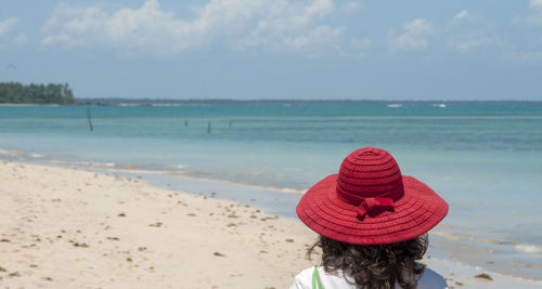 Rear view of woman with umbrella on beach