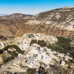 High angle view of residential district by mountain