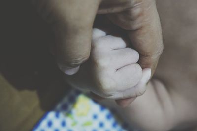 Close-up of hands holding baby hand