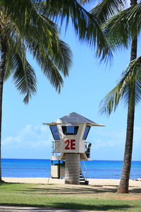 Lifeguard hut on beach against sky