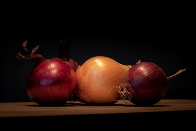 Close-up of fruits on table against black background