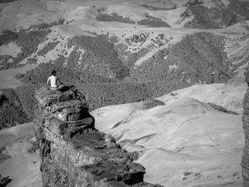 Rear view of man on rock