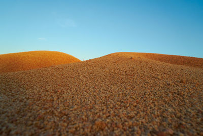 Surface level of desert against sky