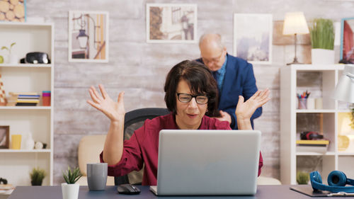 Young woman using laptop at home