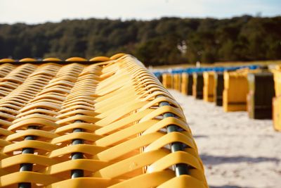 Close-up of chairs on beach