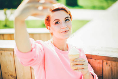 Portrait of smiling young woman using mobile phone