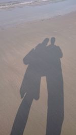 Shadow of man on sand