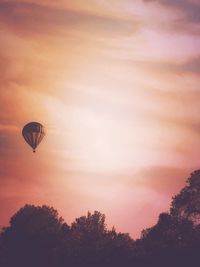 Low angle view of hot air balloon against sky during sunset