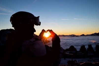 Close-up of silhouette man against sky during sunset