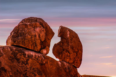 Rock formation in sea against sky