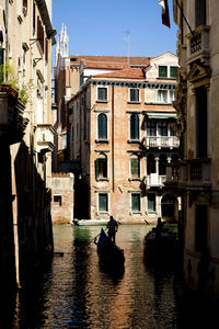 Canal amidst buildings in city