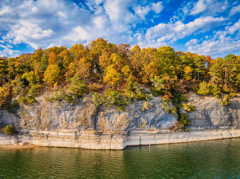 Scenic view of river against sky during autumn