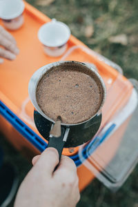 Close-up of hand holding coffee cup