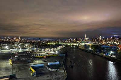 High angle view of illuminated buildings against sky at night