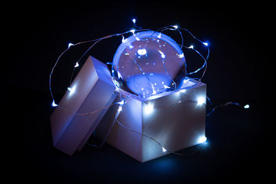 Close-up of illuminated lamp against black background