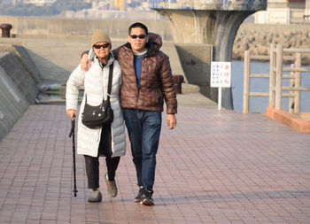 Full length of a smiling young man with his mom