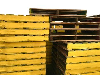 Close-up of yellow wooden palettes in warehouse