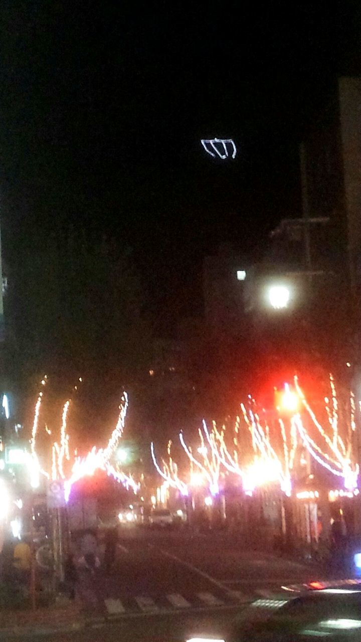 illuminated, night, text, street, transportation, street light, road, lighting equipment, light trail, western script, long exposure, light - natural phenomenon, glowing, car, communication, motion, no people, sky, outdoors, land vehicle