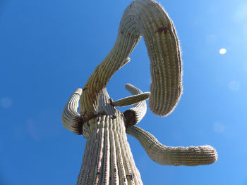 Low angle view of sculpture against clear blue sky