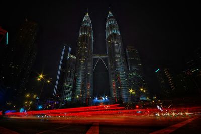 Low angle view of illuminated buildings against sky at night