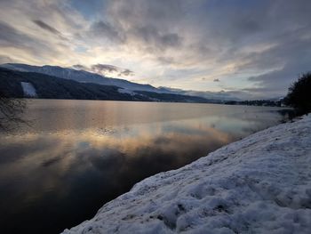 Scenic view of frozen lake against sky during winter
