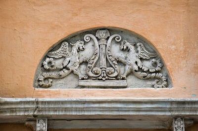Low angle view of carving on wall of historic building