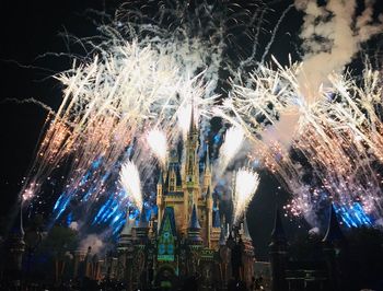 Low angle view of firework display at night