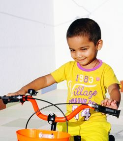 Happy boy riding bicycle at home