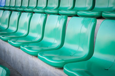 Empty green chairs at stadium