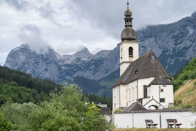Old traditional church in alpine environment with mountains in background, hintersee, germany