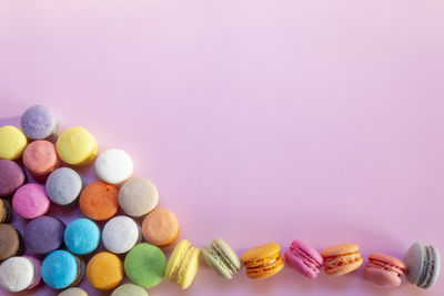 High angle view of multi colored candies against gray background