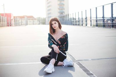 Portrait of woman sitting in city